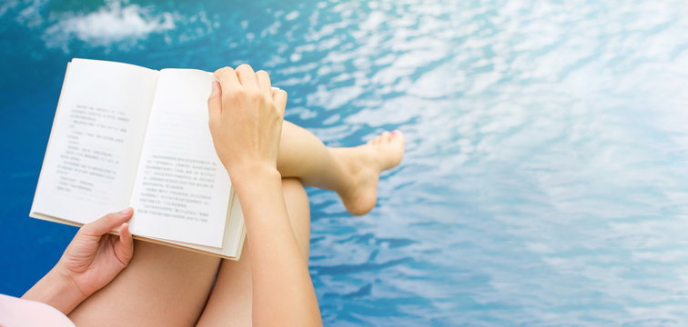 Girl Reading A Book By The Pool