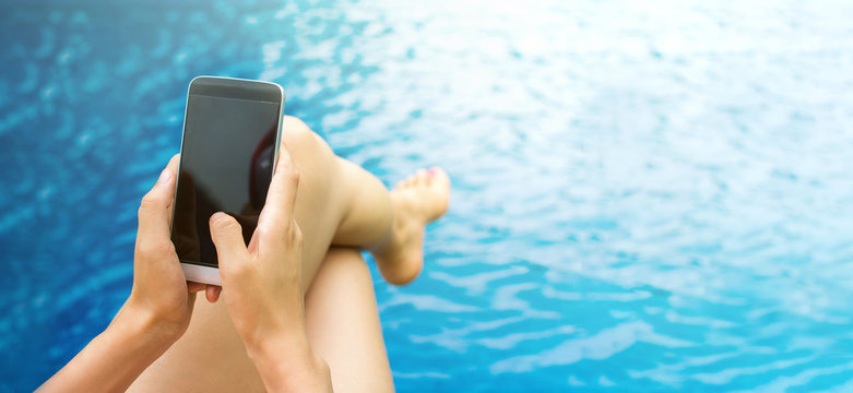 Girl Using Phone By The Swimming Pool