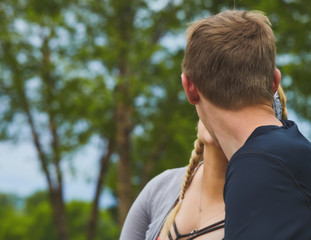 Rear view of young man kissing his girlfriend