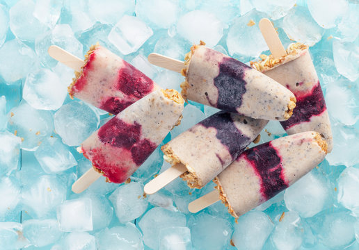 Popsicles with berries, granola and chia seeds. Top view