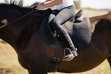 Child riding a horse in the ranch