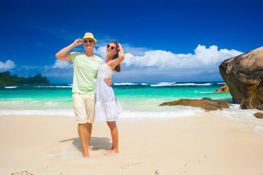 happy young couple having fun by the beach. Seychelles. Mahe Island. Baie Lazare beach
