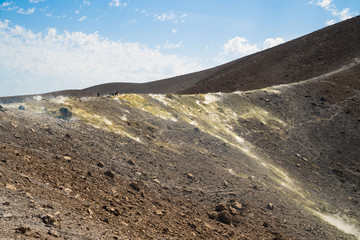 Rim of the crater littered with smoky fumaroles