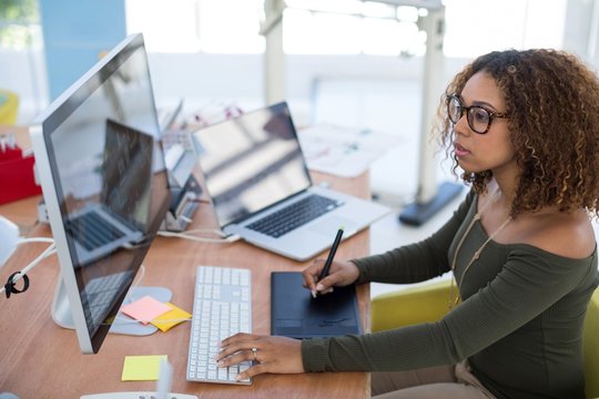 Female Graphic Designer Working On Computer While Using Graphic 