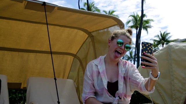 Fun Teen Girl Sits In Beach Cabana, Takes Funny And Cute Selfies 