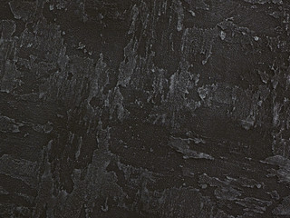 Dark gray black venetian plaster background texture. Traditional venetian plaster texture grain...