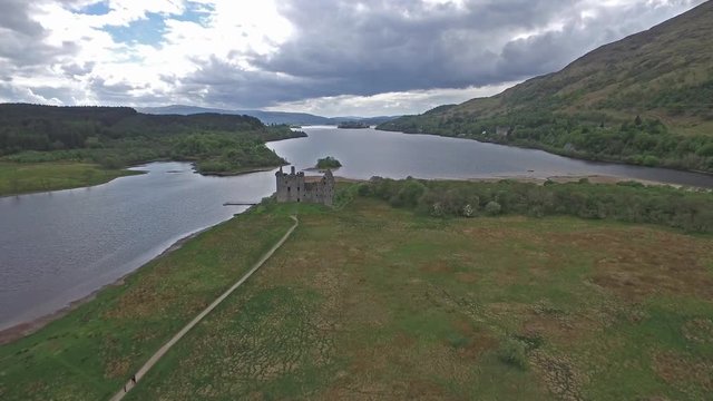 The ruins of historic Kilchurn Castle and jetty on Loch Awe