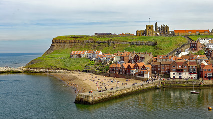 View across the harbor of the east cliff of the popular tourist town of Whitby in North Yorkshire, England