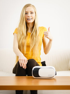 Happy young woman next to VR