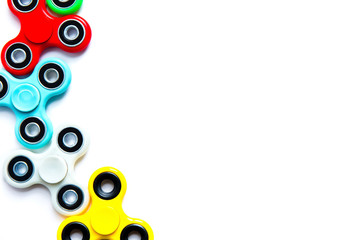 Fidget finger spinner, anxiety relief toy on white isolated background, copyspace. Concept relieving stress