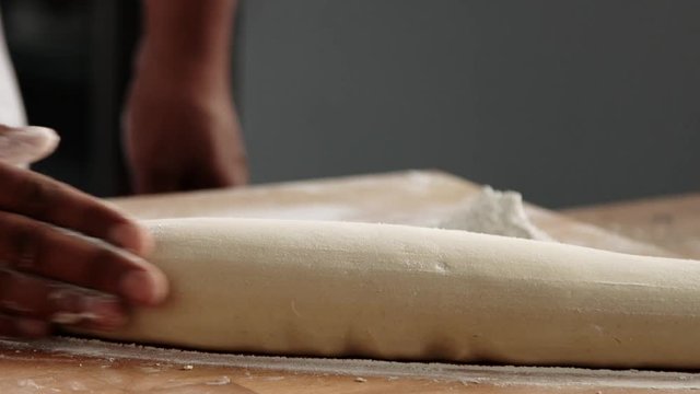 man with dough making a bread