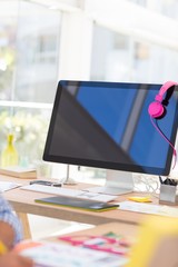 Computer with headphones at desk