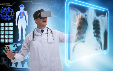 Fototapeta na wymiar Doctor examining x-ray images using virtual reality glasses