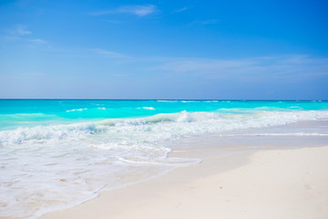 Idyllic tropical beach on Cuba in Caribbean with white sand, turquoise ocean water and blue sky