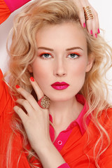 Young beautiful stylish blond woman with fancy bright make-up and manicure