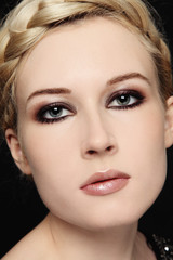 Close-up portrait of beautiful stylish young blond woman with smokey eyes