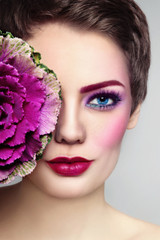 Close-up portrait of young beautiful woman with bright fancy make-up