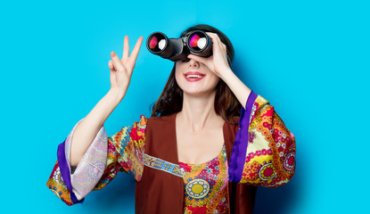Young hippie girl with binoculars