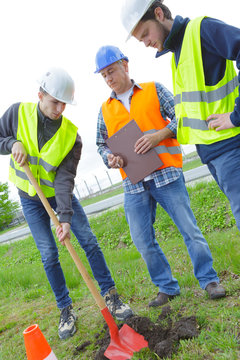 physical workers with shovel and safety helmet