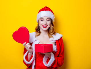 Santa Claus girl in red clothes with gift box