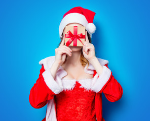 Santa Claus girl in red clothes with gift box