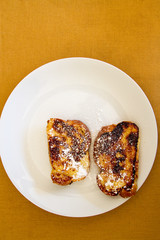 French toast on mustard background 