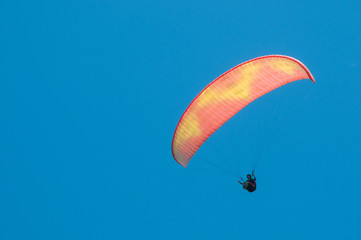 Paraglider flies paraglider in the sky. Paragliding.