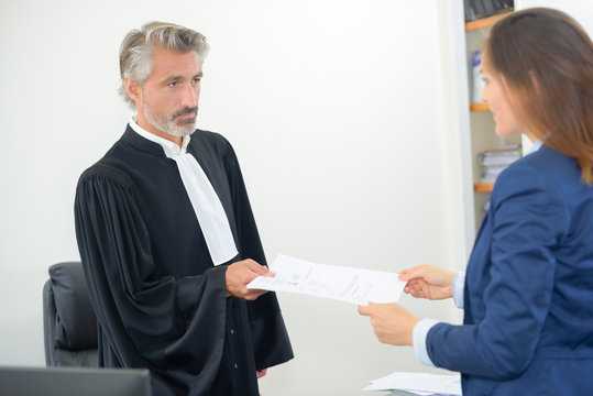 judge giving paperwork of a verdict