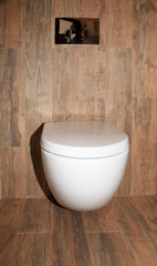 Naklejka na ściany i meble White toilet bowl in a modern bathroom