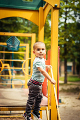 Little boy is a bright playground. Joyful child Summer holidays.