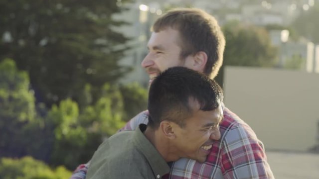 Cute Gay Couple Kiss And Flirt On A Rooftop At Sunset In San Francisco 