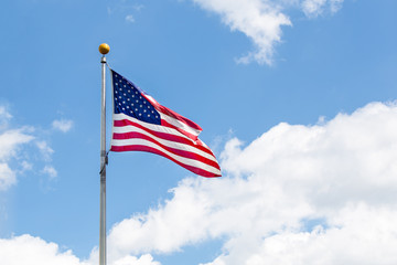 The american Flag waving over blue sky