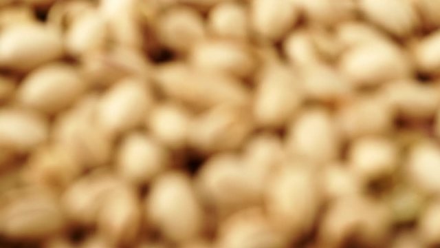 Food background. Roasted pistachio nuts seed with shell close up. Dieting concept. rack focus 4K ProRes HQ codec