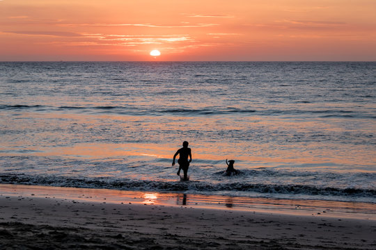 Man and dog silhouette at Beautiful sunset in Mancora Beach - Mancora, Peru