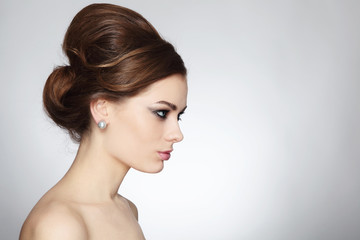 Young beautiful woman with stylish make-up and hair bun