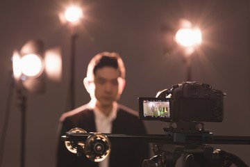 Close-up of video camera photographing model
