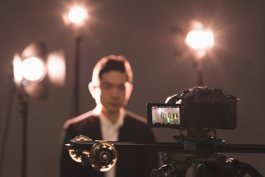 Close-up of video camera photographing model