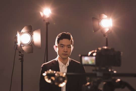 Video camera photographing male model