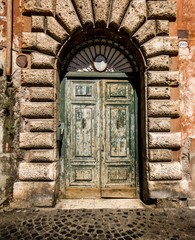 Wooden green antique door in Rome