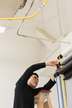 Male photographer adjusting backdrop