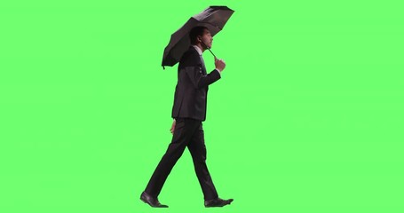 Businessman in a Suit Opens Umbrella While Walking. Shot on Mock-up Green Screen.