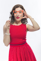 Naklejka premium Portrait of Sensual Alluring Caucasian Brunette Girl Holding Artistic Spectacles In Front Of Face.Against White Background