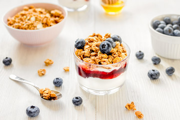 Healthy morning with granola breakfast on white kitchen table