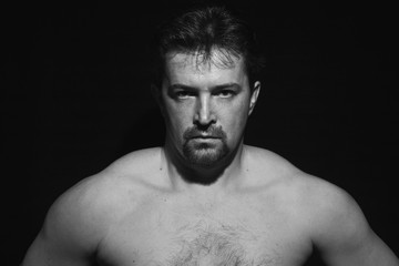 Fototapeta premium Muscular man showing his muscles