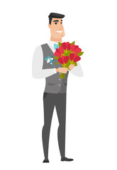 Caucasian groom holding a bouquet of flowers