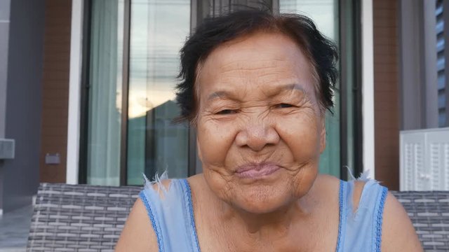 4k video of Senior woman laughing. Smiling female at home