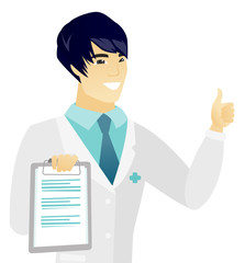 Young asian doctor with clipboard giving thumb up.