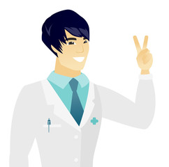 Young asian doctor showing the victory gesture.