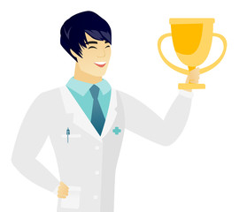 Young asian doctor holding a golden trophy.