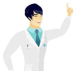 Young asian doctor pointing with his forefinger.